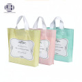 Hermosas bolsas de compras plegables de impresión personalizadas con asa de plástico de bucle duro